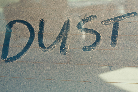 dust written on a dusty window