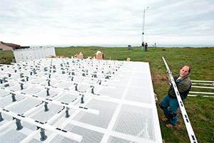 PSL electronics engineer Tom Ayers installs equipment at the first observatory in the 'picket fence', which was deployed at Bodega Bay, CA in 2013. (Photo credit: California DWR)