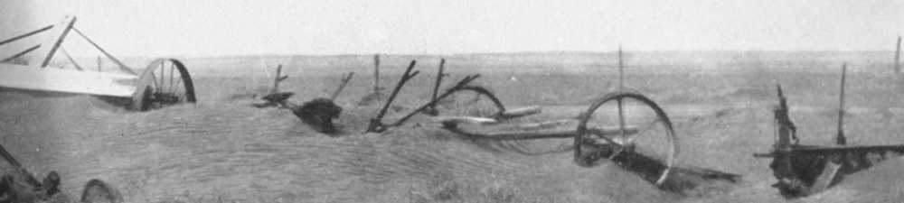 Drifting dust buries abandoned farm equipment in Kansas during the 1930s Dust Bowl. (Credit: NOAA)